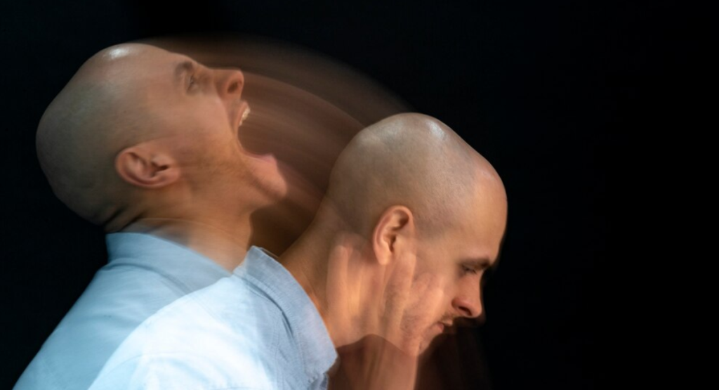 A double face image of a man showing contrasting manic and depressive emotions, illustrating the extreme mood swings that require bipolar disorder treatment in Mohali.